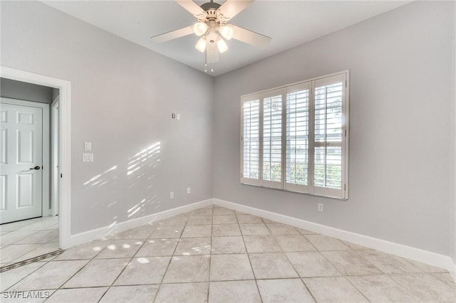 unfurnished room with light tile patterned floors and ceiling fan