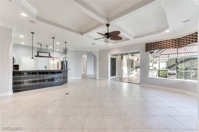 unfurnished living room featuring beam ceiling, crown molding, coffered ceiling, and ceiling fan