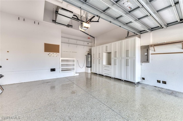 garage with a garage door opener, electric panel, and water heater