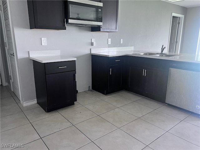 kitchen featuring light tile patterned floors and sink