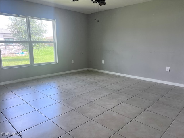 empty room featuring light tile patterned floors and ceiling fan