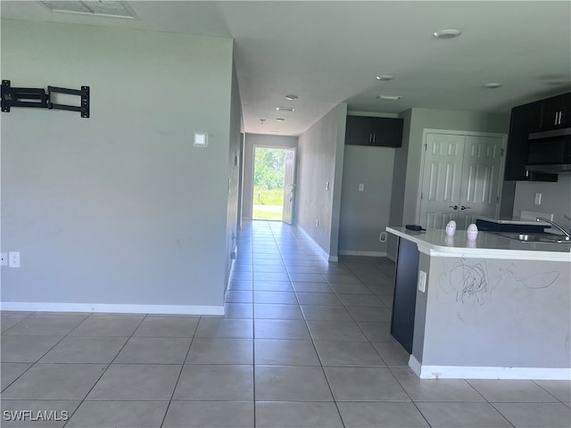 kitchen featuring light tile patterned flooring and sink