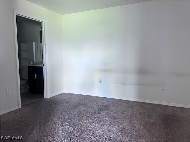 unfurnished room featuring carpet