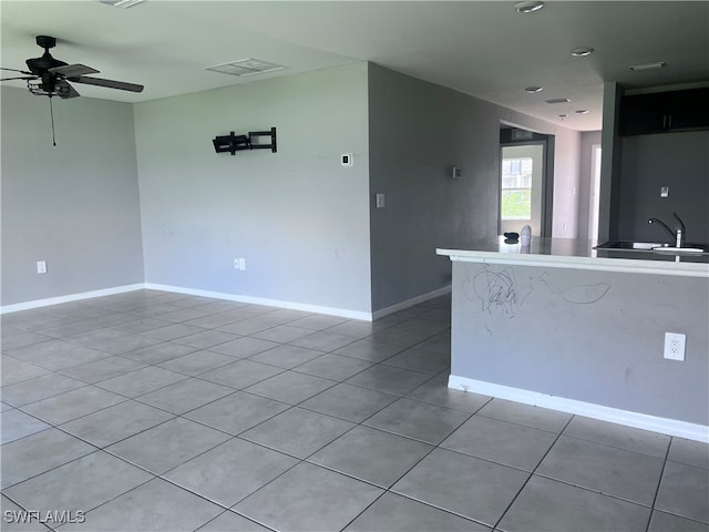 interior space featuring light tile patterned floors, sink, and ceiling fan