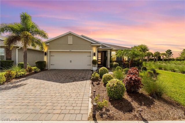 ranch-style home featuring a garage