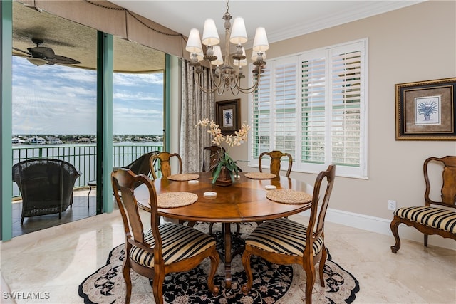 dining space with ceiling fan with notable chandelier, crown molding, and a water view