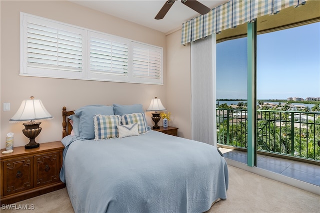 bedroom featuring ceiling fan, light colored carpet, and multiple windows