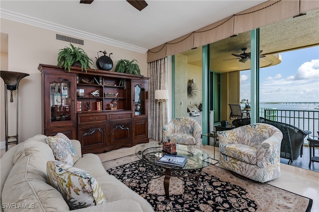 tiled living room featuring ornamental molding, a water view, and ceiling fan