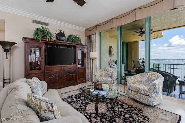 tiled living room featuring ornamental molding and ceiling fan