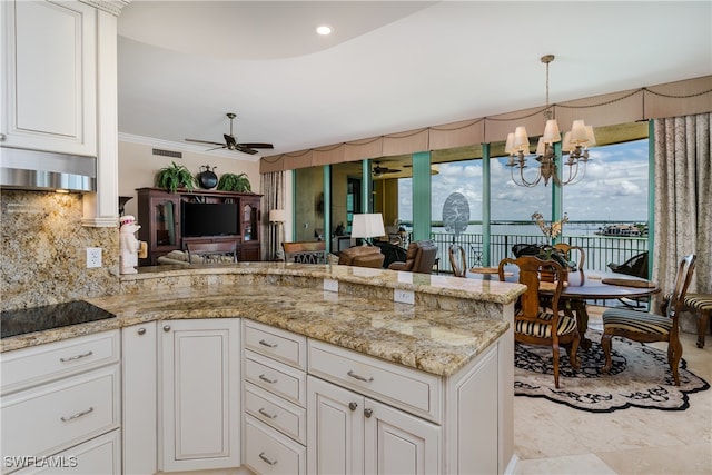 kitchen with decorative backsplash, white cabinetry, ceiling fan with notable chandelier, ventilation hood, and black electric stovetop