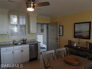 kitchen with ceiling fan, sink, white cabinetry, dishwasher, and crown molding