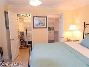 bedroom featuring a closet and ornamental molding