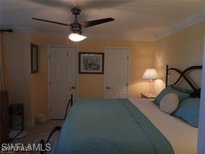 bedroom with ornamental molding and ceiling fan