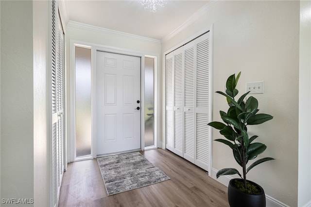 entryway with ornamental molding and light wood-type flooring