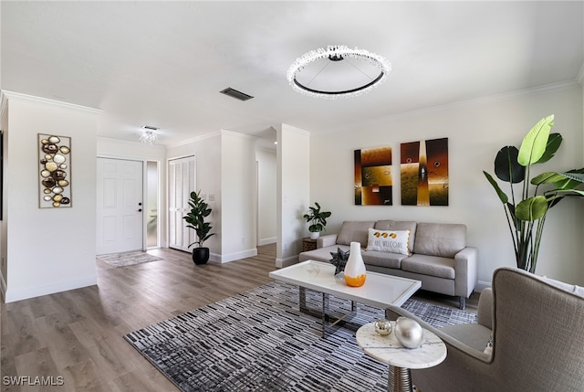 living room with ornamental molding and hardwood / wood-style flooring