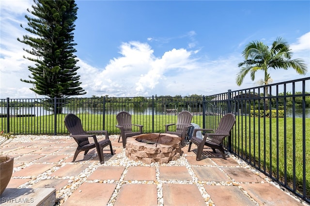 view of patio / terrace featuring a water view and a fire pit