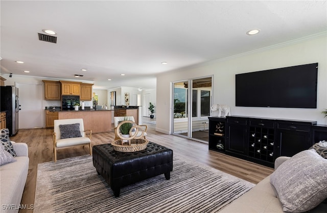 2110 Sebastian Ct, Alva, FL 33920 - living room with crown molding, light wood finished floors, and recessed lighting
