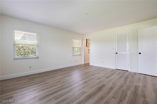 interior space featuring multiple windows and light hardwood / wood-style floors