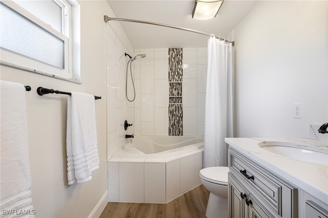 full bathroom with shower / tub combo with curtain, vanity, toilet, and hardwood / wood-style flooring