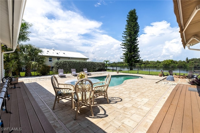 view of pool featuring a patio and a water view