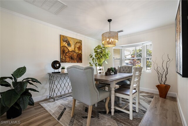 2110 Sebastian Ct, Alva, FL 33920 - dining room with a chandelier, baseboards, wood finished floors, and crown molding