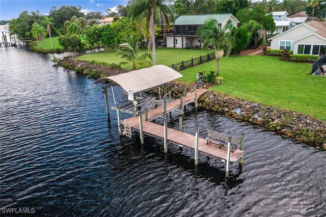 view of dock featuring a water view and a yard