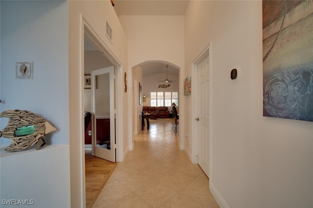 hallway featuring light hardwood / wood-style floors and vaulted ceiling