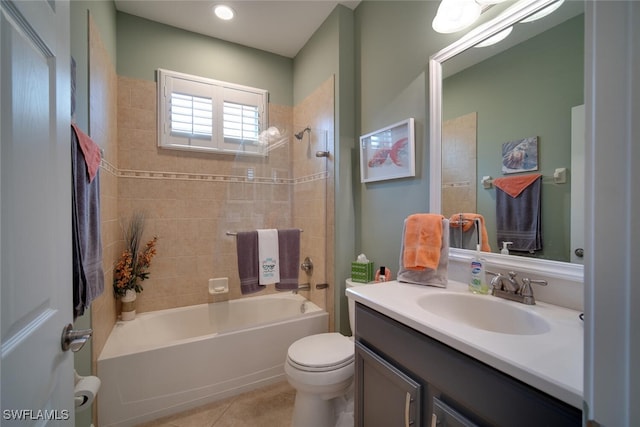 full bathroom featuring vanity, tile patterned floors, tiled shower / bath, and toilet