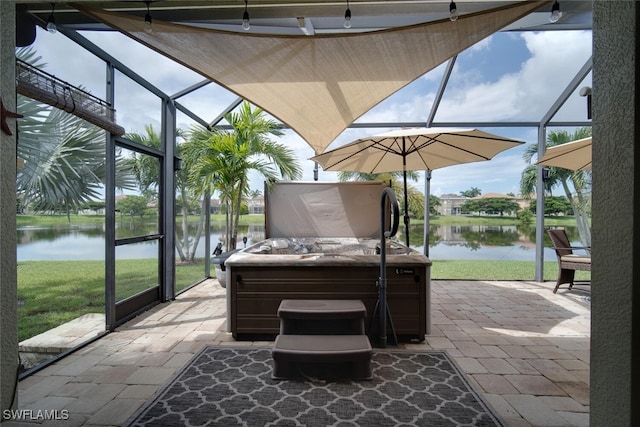 view of patio featuring a lanai, a hot tub, and a water view