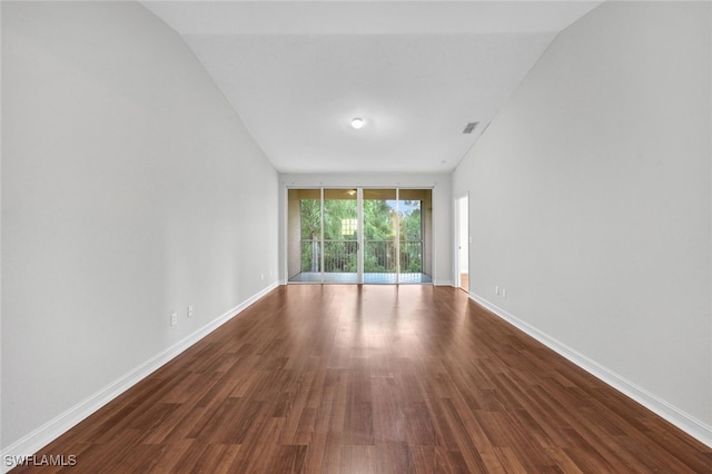 empty room with expansive windows and hardwood / wood-style flooring