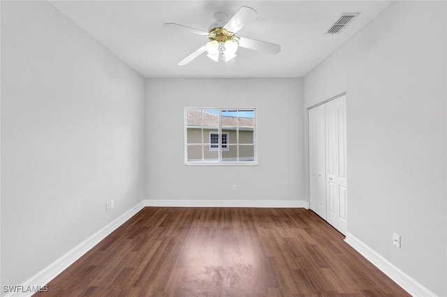 spare room with ceiling fan and dark hardwood / wood-style floors