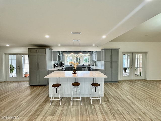 kitchen featuring gray cabinetry, a wealth of natural light, and french doors