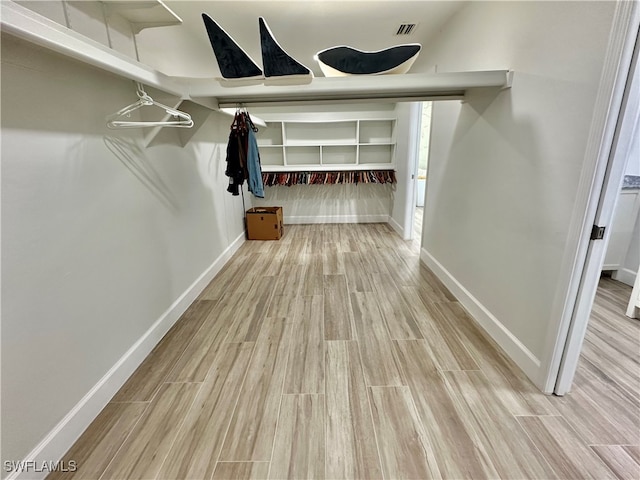 walk in closet featuring light hardwood / wood-style floors