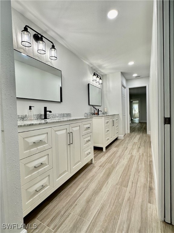 bathroom featuring hardwood / wood-style flooring and vanity