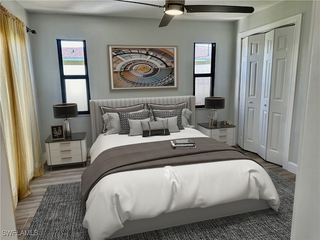 bedroom with wood-type flooring, ceiling fan, and a closet