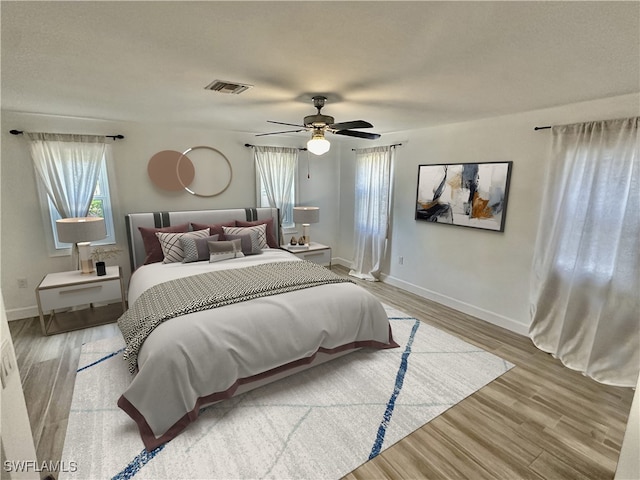 bedroom with light wood-type flooring and ceiling fan