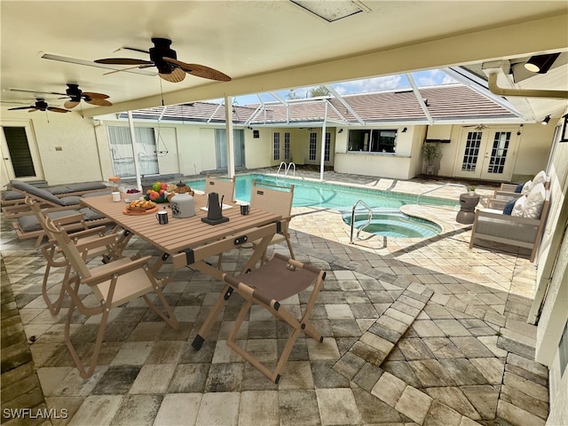 view of pool featuring a patio area, an in ground hot tub, glass enclosure, ceiling fan, and french doors