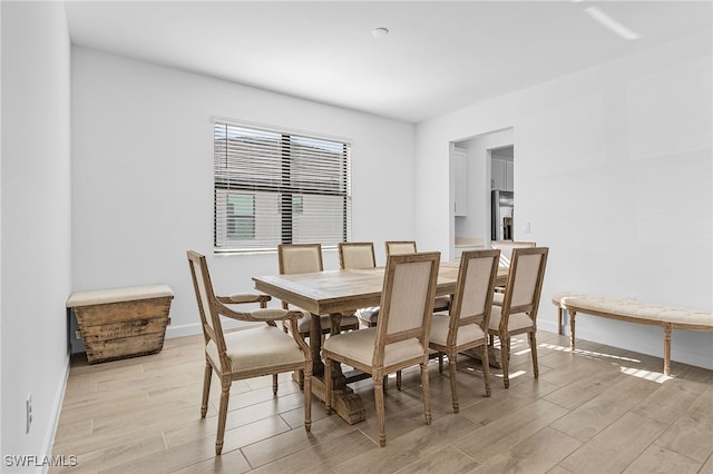 dining area with light hardwood / wood-style floors