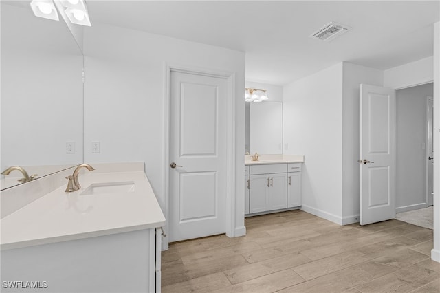 bathroom with vanity and hardwood / wood-style floors