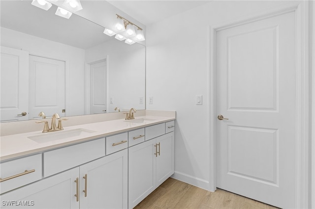 bathroom featuring hardwood / wood-style flooring and vanity