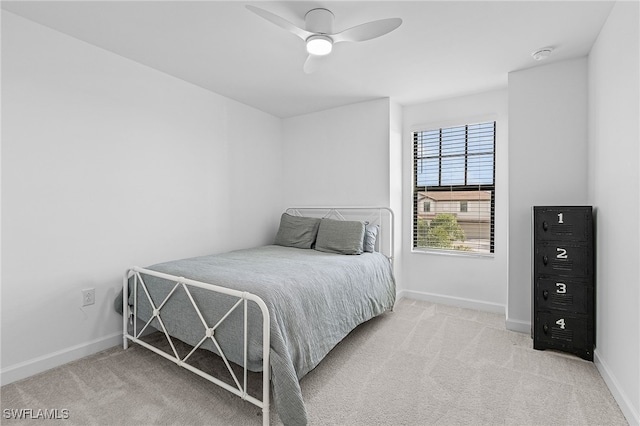 bedroom featuring ceiling fan and light carpet