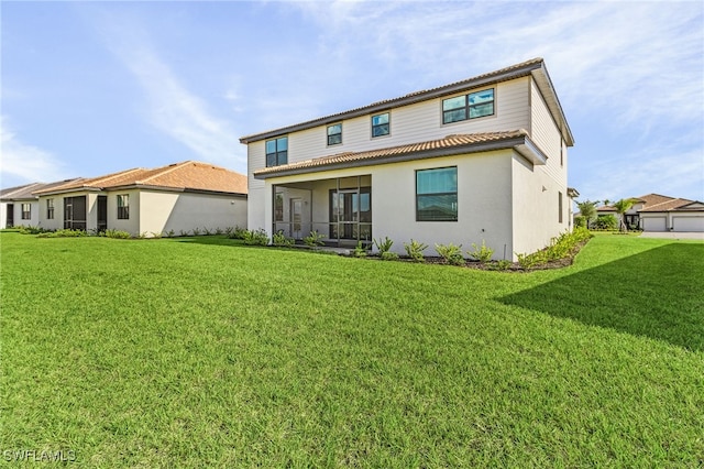 back of property with a yard and a garage