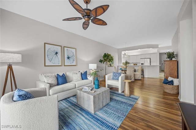 living room with hardwood / wood-style flooring and ceiling fan