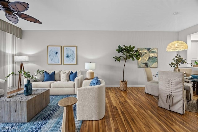 living room featuring dark hardwood / wood-style flooring and ceiling fan