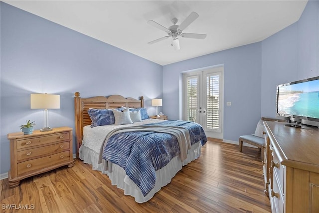 bedroom with hardwood / wood-style flooring, ceiling fan, french doors, and access to exterior