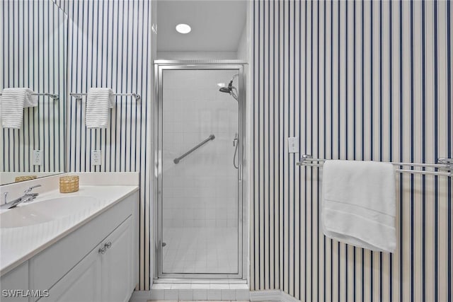 bathroom featuring vanity and a shower with shower door