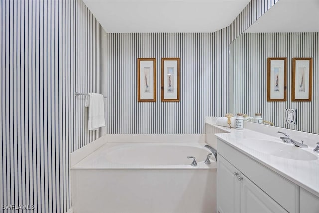 bathroom with vanity and a bathtub