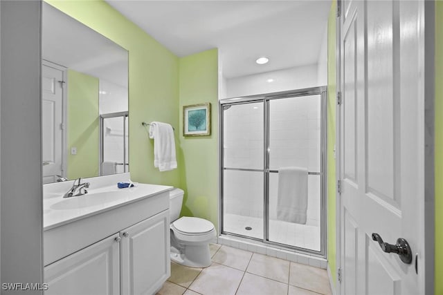 bathroom with vanity, toilet, tile patterned floors, and walk in shower