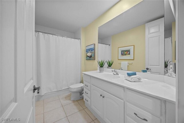 bathroom featuring toilet, vanity, tile patterned flooring, and a shower with shower curtain