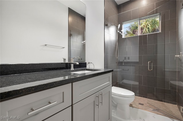 bathroom featuring vanity, toilet, and an enclosed shower